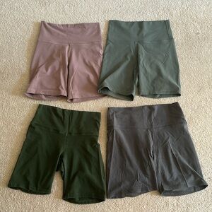 Set of 4 TNA biker shorts - 2 dark green, 1 grey and 1 purple - Size S & M